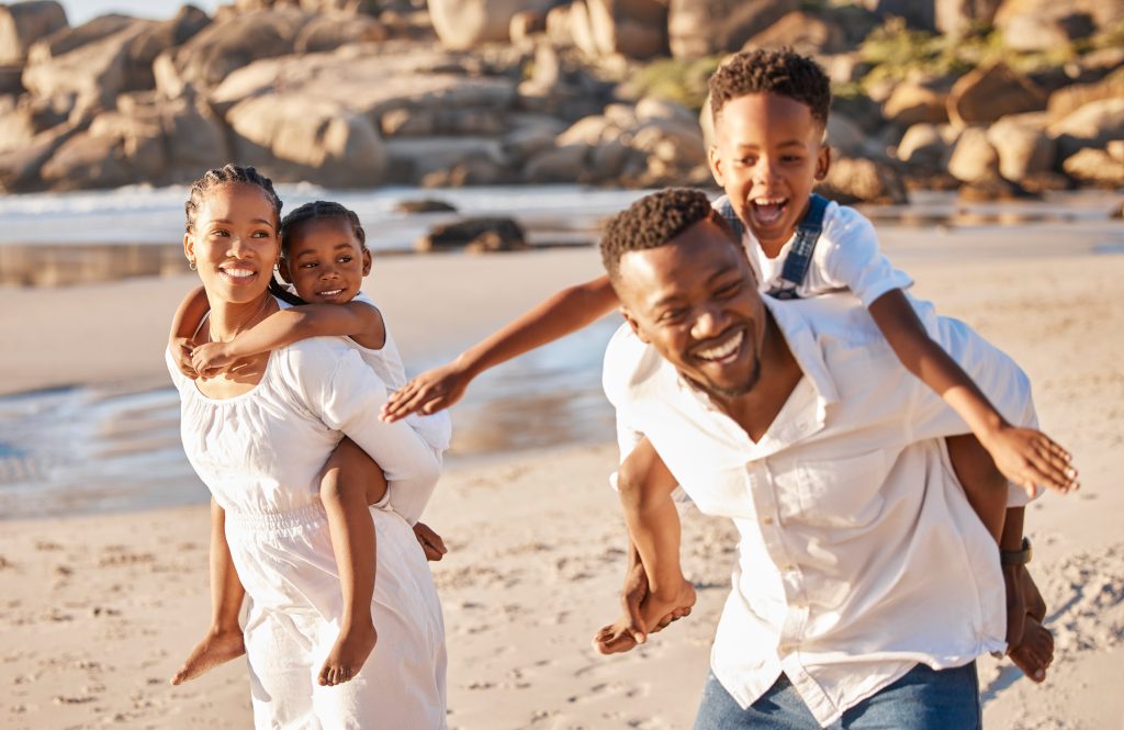 Family piggyback fun on the beach – uMhlanga Rocks family holiday guide for a fun weekend getaway